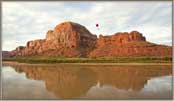 Flying Lawn Mowers above river and formation.